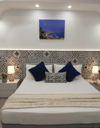 a bedroom with a large white bed with two lamps at Capodimonte Home in Naples