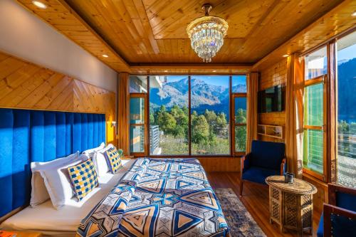 a bedroom with a bed and a large window at The 14 Gables, A Boutique Stay, Manali - Pet Friendly - Balcony Rooms - Crown Palace in Manāli