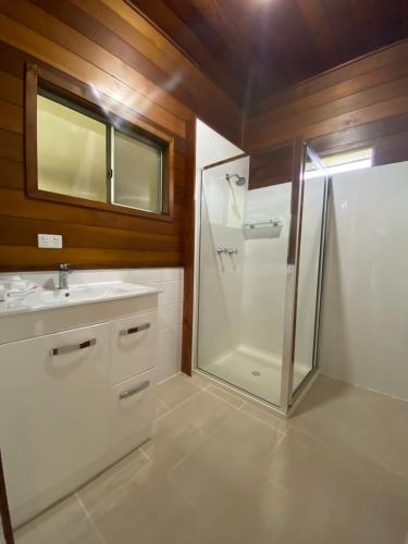 a bathroom with a shower and a sink at Wild Platypus Stays in Eungella