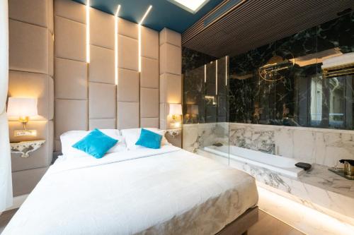 a bedroom with a large bed and a bath tub at Lary's - San Pietro in Rome