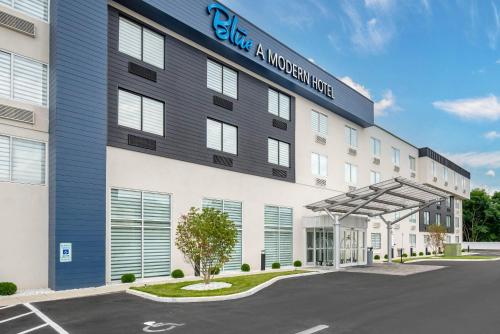 a building with a sign on the side of it at Blue - A Modern Hotel, an Ascend Collection Hotel in West Springfield