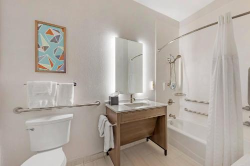 a bathroom with a toilet and a sink and a shower at Comfort Inn Sullivan in Sullivan