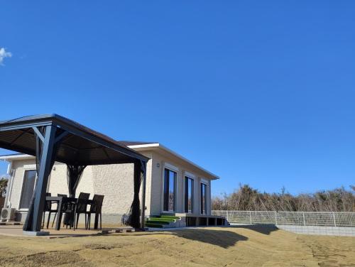 a gazebo in front of a house at Seaside House Cozy - Vacation STAY 03320v in Sanmu