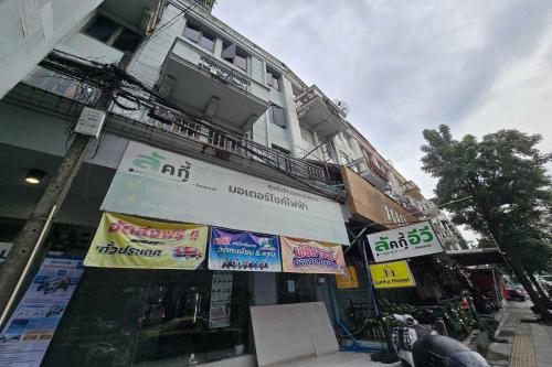 a building with signs on the side of it at Sukhum Huai Khwang Guest House in Bangkok
