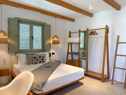 a bedroom with a bed and a ladder and windows at Carpe Diem Boutique Hotel - Adults Only in Side