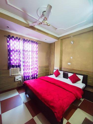 a bedroom with a large red bed with red pillows at Hotel Ishaan International Near Yatra Parchi Counter 2 in Katra