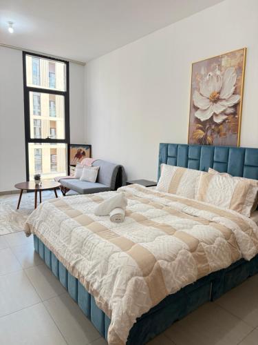 a bedroom with a large bed in a room at Modern studio with pool and fiber connection in Sharjah