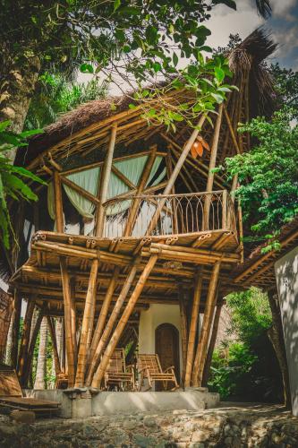 a large wooden house with a large deck at Bamboo Hill in Lương Sơn