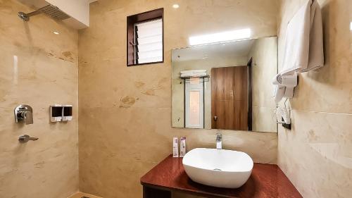 a bathroom with a sink and a mirror at Yashshree Dewathang Resort in Lachung