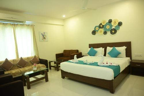 a bedroom with a bed and a living room at Hotel Casa Lorven Near Golf Course in Visakhapatnam