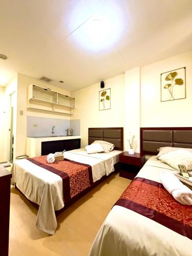 a hotel room with two beds in a room at Isla Boracay Inn in Boracay