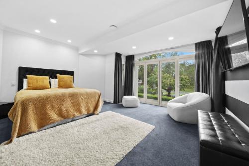 a bedroom with a bed and a large window at Renall St Gem Central Masterton in Masterton