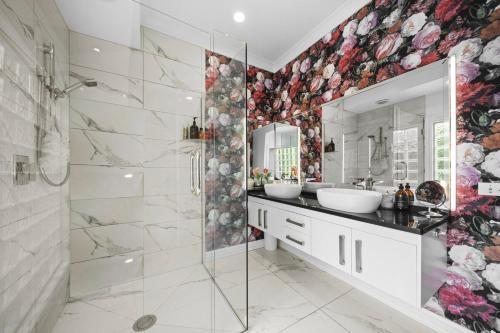 a bathroom with two sinks and a glass shower at Renall St Gem Central Masterton in Masterton