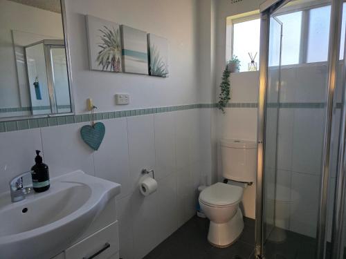 a bathroom with a toilet and a sink at CHILL-OUT BEACHSIDE - Main Beach Forster in Forster