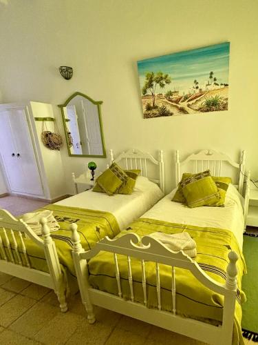 two beds sitting next to each other in a bedroom at Dar Lola Djerba in Houmt Souk