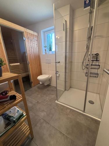 a bathroom with a shower and a toilet at Strandläufer in Tossens