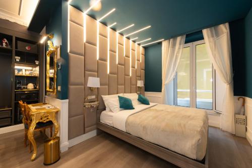 a bedroom with a large bed with blue walls at Lary's - San Pietro in Rome