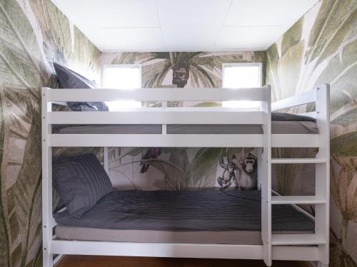 a bunk bed in a room with a wall at Ermrest Cottage in Erm