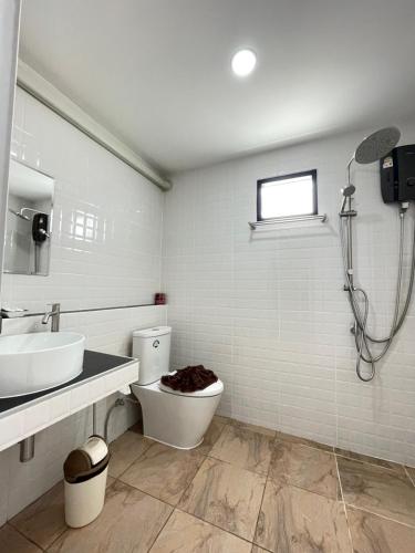 a bathroom with a toilet and a sink and a shower at Ron Bungalow in Bang Tao Beach