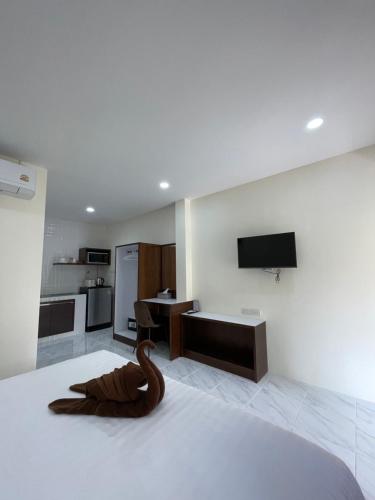 a room with a bed with a wooden snake on it at Ron Bungalow in Bang Tao Beach