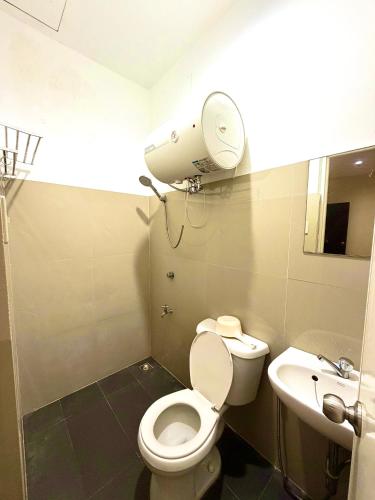 a small bathroom with a toilet and a sink at Isla Boracay Inn in Boracay
