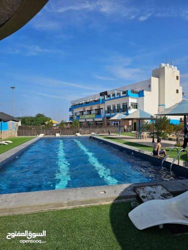 a large swimming pool in front of a building at Larain Plaza Hotel in Aqaba