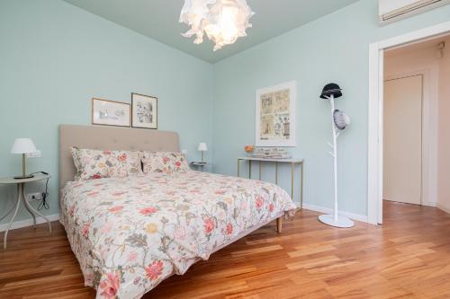 a bedroom with a bed and a lamp on a wooden floor at Charme a Bergamo in Bergamo