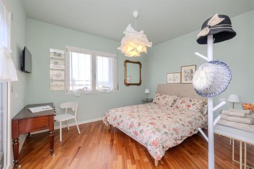 a bedroom with a bed and a desk and a desk at Charme a Bergamo in Bergamo