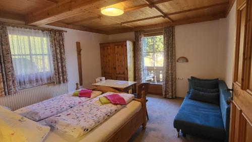 a bedroom with two beds and a table and a chair at Stefflhof Mittersill in Mittersill