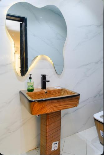 a bathroom with a wooden sink and a mirror at The Lekki Retreat in Lekki