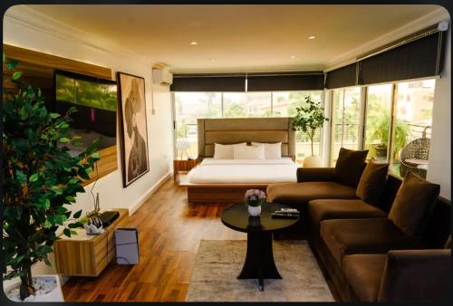 a living room with a bed and a couch at The Lekki Retreat in Lekki
