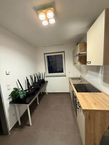 a kitchen with a counter and a table in it at AM Apartment 8 in Gronau