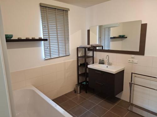 a bathroom with a tub and a sink and a mirror at Jagdschloss Friedrichsthal in Waldeck