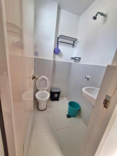 a bathroom with a toilet and a sink at Blessed Inn Annex in El Nido
