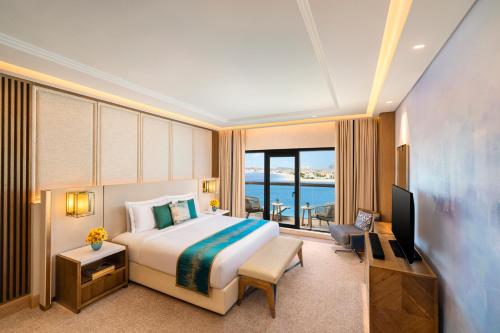 a hotel room with a bed and a television at Taj Exotica Resort & Spa, The Palm, Dubai in Dubai