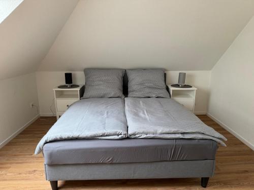 a bed in a room with two night stands at Stadtwohnung Bocholt in Bocholt