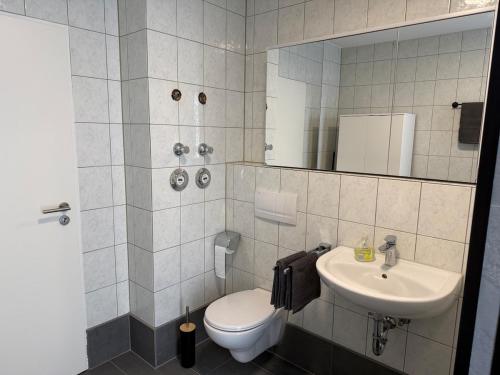 a bathroom with a toilet and a sink at Stadtwohnung Bocholt in Bocholt