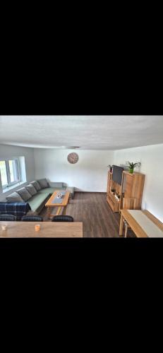a living room with a couch and a table at Gästezimmer Mürztal in Langenwang Schwöbing