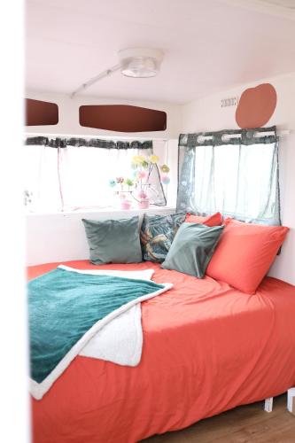 a bed in the back of a rv at Caravane cocooning in Saint-Martin-des-Noyers