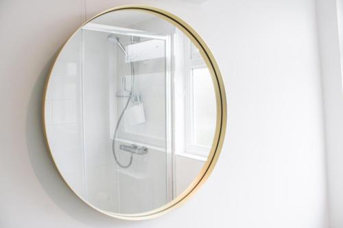 a mirror in a bathroom with a shower at 4 Lyndhurst in Salcombe