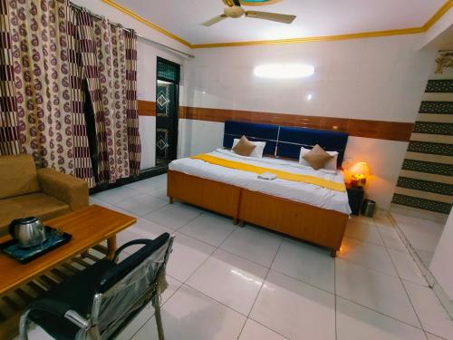 a bedroom with a bed and a couch and a desk at S D palace in Dighori