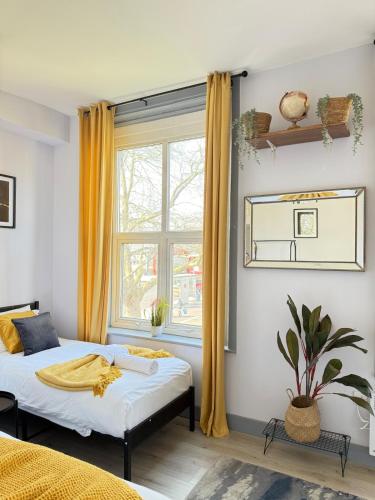 a bedroom with two beds and a window at The Wolfs Tavern in London