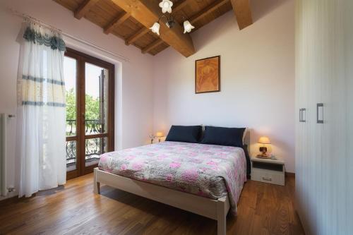 a bedroom with a bed and a window at Casamorena in Montegabbione