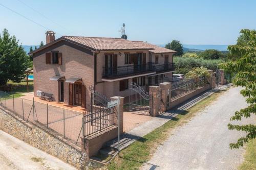 a house with a fence in front of a road at Casamorena in Montegabbione