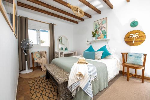 a bedroom with a bed and a table and a chair at Beachfront two bedrooms house Casa Toral in Majanicho
