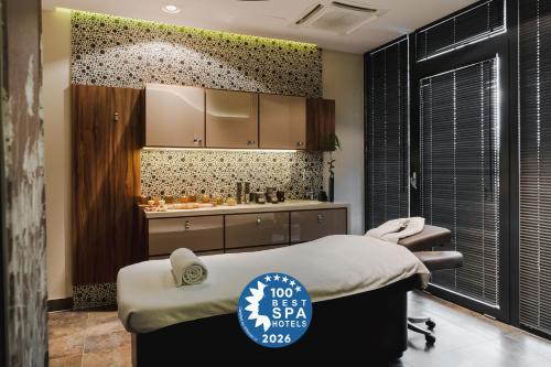 a hospital room with a bed and a sink at Hotel Mikołajki Leisure & SPA - Destigo Hotels in Mikołajki
