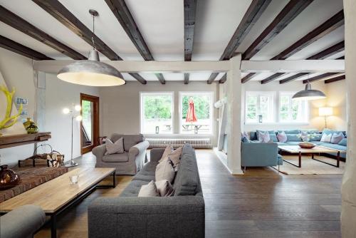 a living room with a couch and a table at Haus im Wald in Gartow
