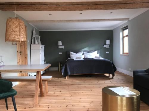 a bedroom with a bed and a wooden floor at Hiestand's Gästehaus - Weingut & Hofbrennerei in Guntersblum