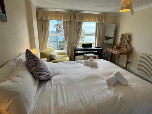 a bedroom with a white bed with towels on it at 2 Bed in Langland oc-hh193 in Newton