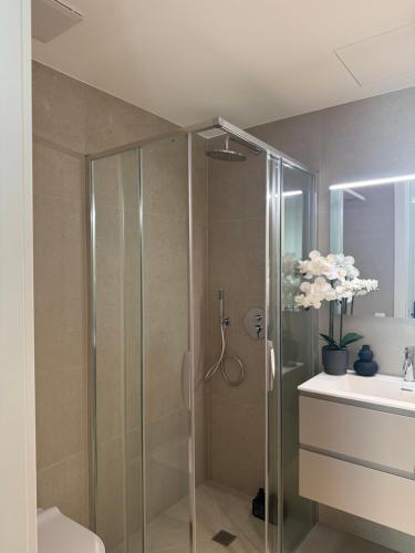 a bathroom with a shower and a sink at Live Lugano - Via Muggina in Viganello